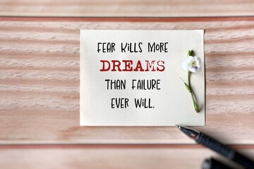 Inspirational Quote - fear kills more dreams than failure ever will. Text on paper background. Stock photo.
