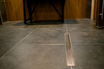 Bathroom floor with drainage grate