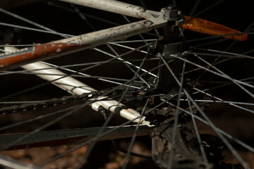 This is a closeup image of a bicycle wheel featuring a chain attached to it, showcasing the...