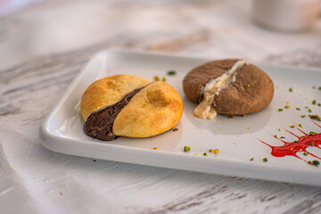 Decadent stuffed cookies. Tempting display of two stuffed cookies, one filled with chocolate and...