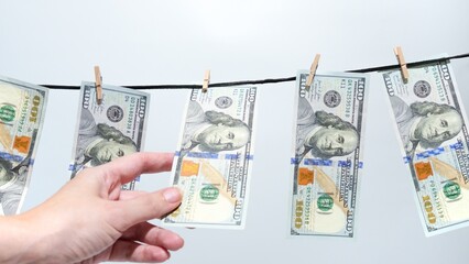 Money Laundering Concept Hundred Dollar Bills Drying on a Clothesline. Financial Crime.