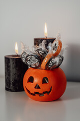  halloween candies and treats in pumpkin bucket , trick or treat concept. Vertical copy space banner