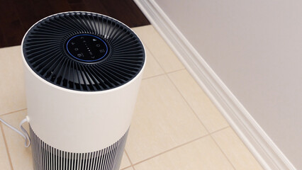 Sleek Modern Tall Air Purifier with Black Fan on Beige Tile Floor in Stylish Room