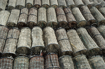 fishing boats, fishermen and fishing traps in the port at Marceddì, Oristano, Sardinia, Italy
