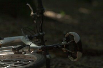 A bicycle is currently positioned on its side resting on the ground surface, indicating it may be...