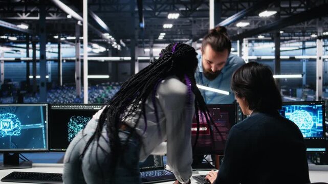 Technicians in AI server hub panicked by hacking attempt stealing sensitive company data. Team of data center IT experts fighting computer virus triggered by security systems, camera A