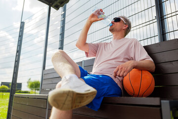 Relaxing at the basketball court after a long game in the sun