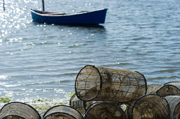 fishing boats, fishermen and fishing traps in the port at Marceddì, Oristano, Sardinia, Italy