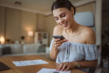 Adult woman have contactless payment scan invoice on cellphone at home