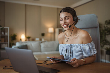 adult woman with headset have web conference while working from home