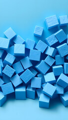 Randomly lying blue foam cubes. Graphic concept. Blue foam cut into cubes. Blue background. Volumetric image. Styrofoam. White tone