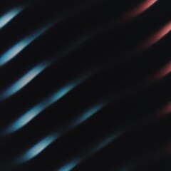 Obraz premium Abstract streaks of light in shades of blue and red on a dark background showing movement and energy.