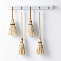 Four Brooms Hanging On White Wall Rack Isolated With Shadows In Studio