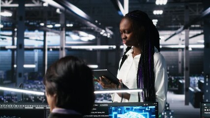 Team of data center developers doing brainstorming, monitoring neural network AI LLM. Teamworking colleagues in high tech facility oversee servers powering machine learning processes, camera A - Powered by Adobe