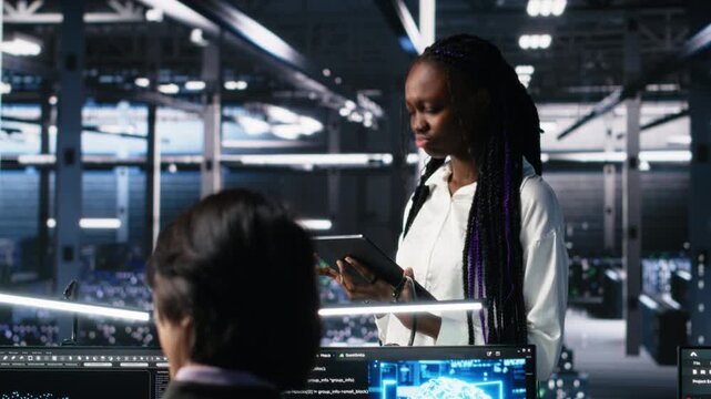 Team of data center developers doing brainstorming, monitoring neural network AI LLM. Teamworking colleagues in high tech facility oversee servers powering machine learning processes, camera A - Powered by Adobe