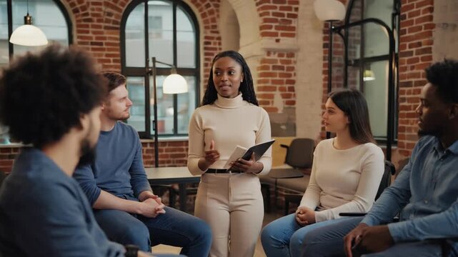 Therapist leading adults through an open dialogue in group therapy meeting