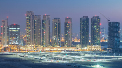 Buildings on Al Reem island in Abu Dhabi day to night timelapse from above.