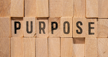 a compass and a paper tag with the word PURPOSE. the concept of purpose.