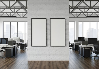 A modern office space featuring a white brick wall with two empty frames and desks with chairs under large windows showing a city view.