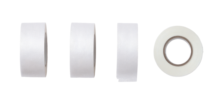Four white cylindrical objects, likely tape rolls