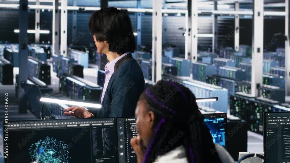 Poster software developers cooperating in data center, reviewing ai diagnostics on computer. it staff membe