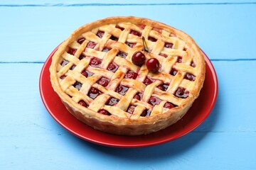 Tasty cherry pie on light blue wooden table, closeup