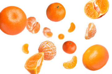 Juicy tangerines swirling in air against white background
