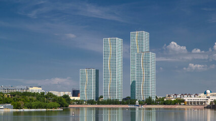 Yesil river timelapse with modern towers of residential complex in Astana