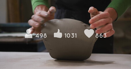 Shaping apron-clad hands molding clay on tabletop in ceramics studio, social media icons overlay