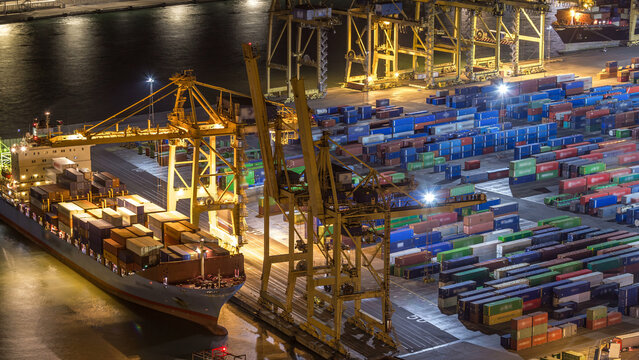 Seaport and loading docks at the port with cranes and multi-colored cargo containers night timelapse - Powered by Adobe