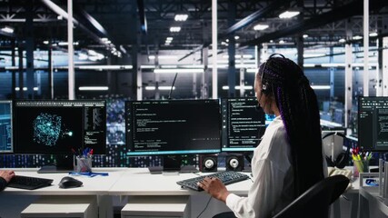 Data center computer scientist using AI assistant to provide user technical support. African american woman in server farm managing live support calls assisted by artificial intelligence, camera A - Powered by Adobe