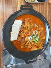 Hearty Braised Pork Kimchi Stew with Tofu and Sesame Seeds