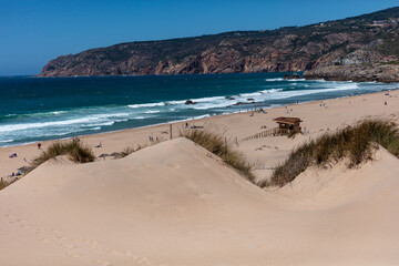 Golden sand dunes and scenic coastline at a popular Algarve beach