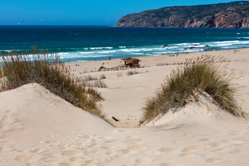 Golden sand dunes and scenic coastline at a popular Algarve beach