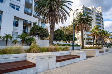 Modern seaside promenade at Beacon Cove in Port Melbourne, Australia, with contemporary apartments,...