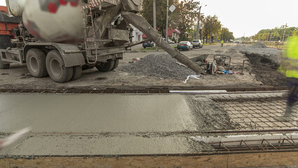 Concrete works for road construction with many workers and mixer timelapse hyperlapse