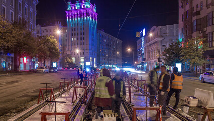 Tram rails at the stage of their installation and integration into concrete plates on the road...
