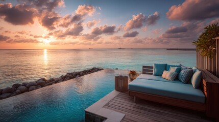Fototapeta premium Tropical sunset over an infinity pool. Luxury beachfront lounge