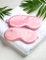Pink Under Eye Masks on Soft Towel with Tropical Leaves jpg