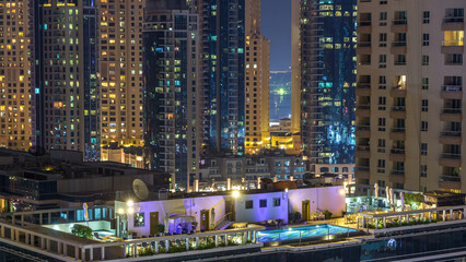 Fototapeta premium Aerial view of Dubai Marina from a vantage point night timelapse.