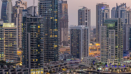 Luxury Dubai Marina canal with passing boats and promenade day to night timelapse, Dubai, United Arab Emirates