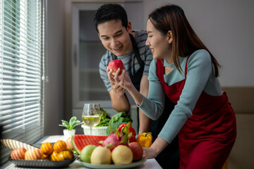 A man and a woman are looking at a fruit