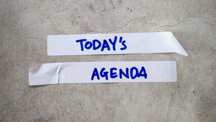 Today's Agenda Text on Paper Strips on a Cracked Concrete Background
