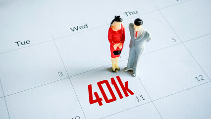 Couple Figurines on a Calendar with 401k Retirement Planning Text