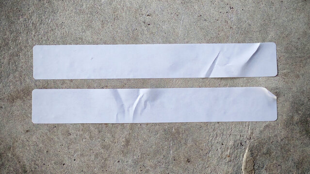 Two Blank White Labels on a Cracked Concrete Background