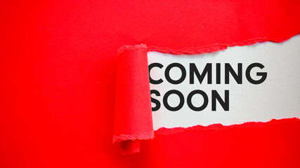 Coming Soon Message Revealed Under Torn Red Paper on White Background
