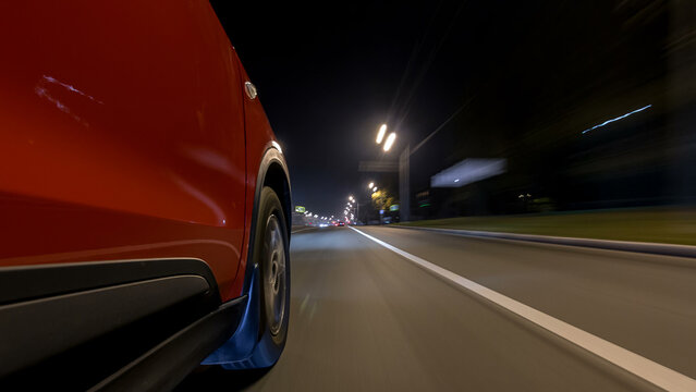 Drivelapse urban look from fast driving car at a night avenue in a city timelapse hyperlapse