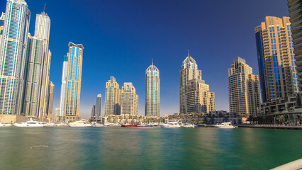 Dubai Marina with tallest skyscrapers and boats timelapse hyperlapse