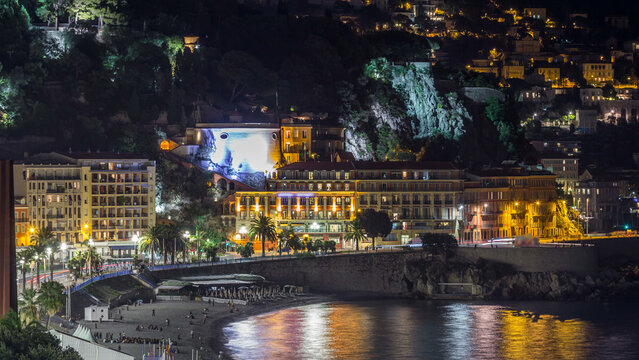Fototapeta Night aerial panorama of Nice timelapse, France. Lighted Old Town little streets and waterfront