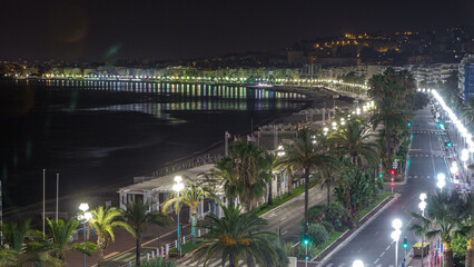 Obraz premium Night aerial panorama of Nice timelapse, France. Lighted Old Town little streets and waterfront